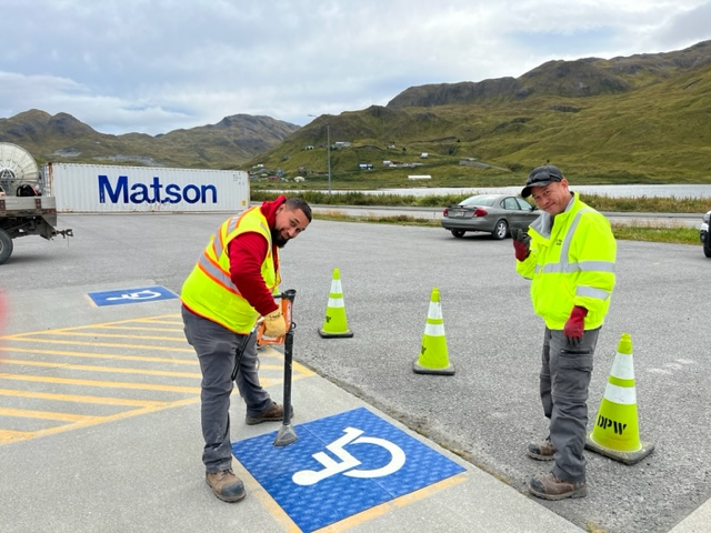 Two Public Works employees resurfacing the handicap parking spots for Eagle's View Elementary School